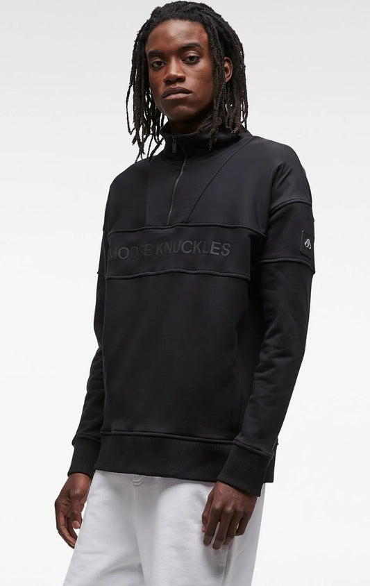 A Black sweatshirt with a partial zipper neck and the words MOOSE KNUCKLES across the chest.