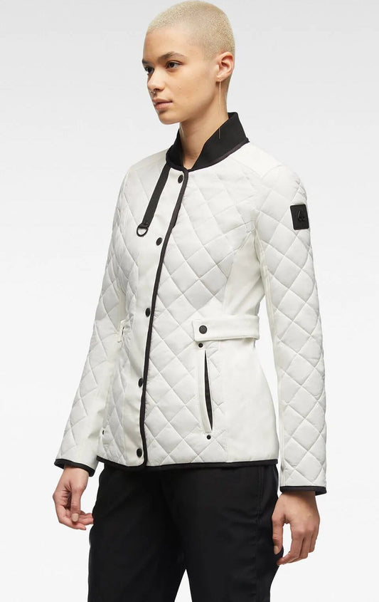 A woman wears a quilted, white jacket with black trim and accents.