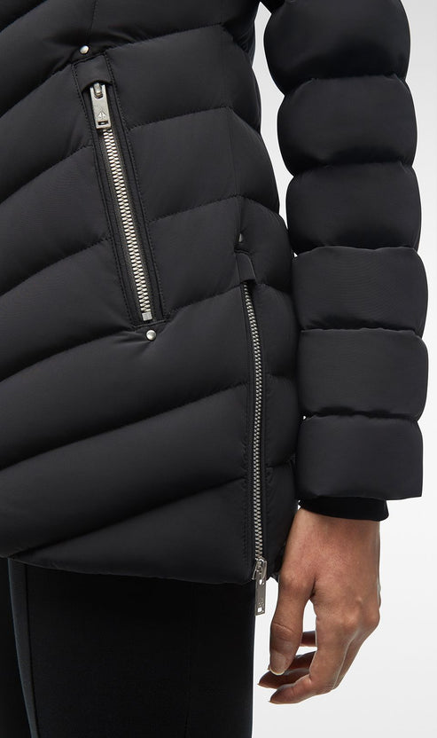 Close-up of a black puffer jacket with silver zippers on the side and arm.