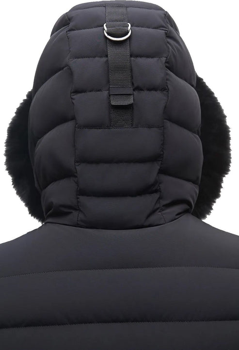 Close-up of the back of a black puffer coat with a large, quilted hood and faux fur trim.