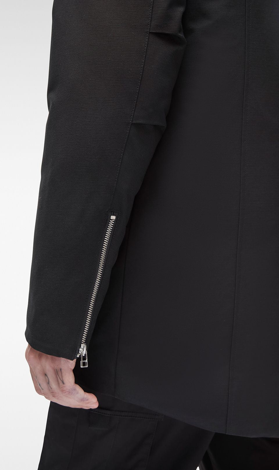 Black jacket sleeve with zipper.