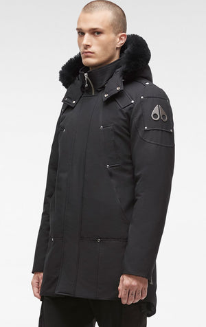 A black parka jacket with a fur-lined hood and the logo of a moose on the left sleeve.
