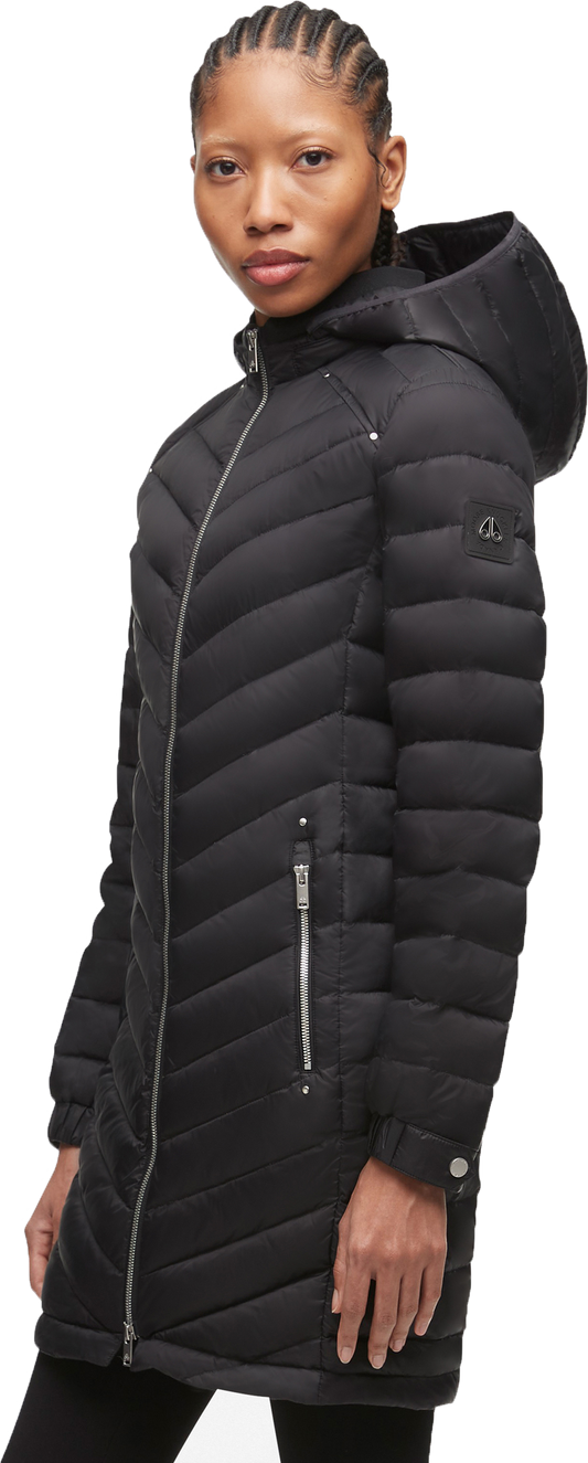 A woman wears a black quilted puffer coat with a hood.
