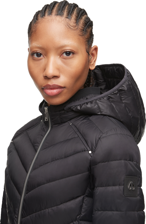 Person wearing a black down-filled puffer jacket with a hood.