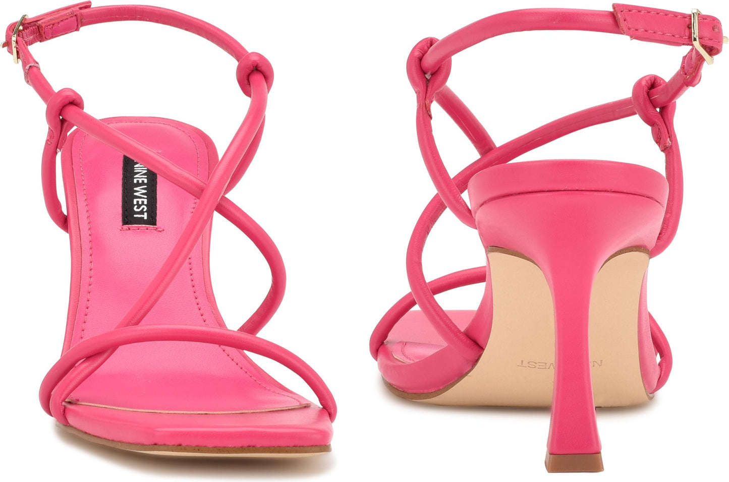 Pair of hot pink high-heeled sandals with knot and criss-cross strap detail and text "NINE WEST".