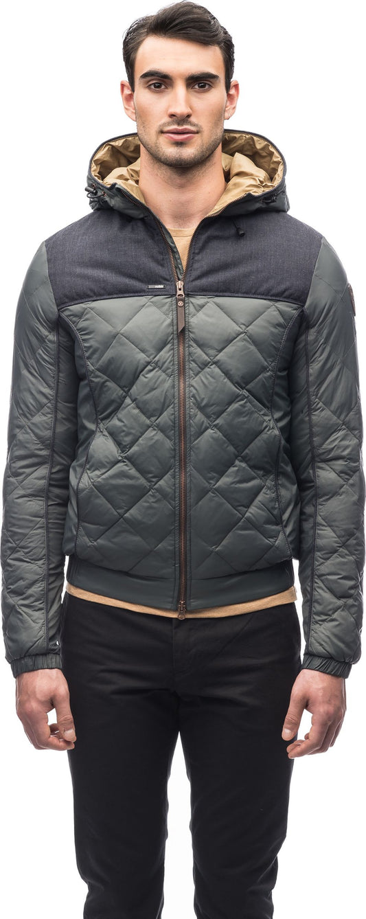 A man wearing a quilted puffer jacket with a hood.