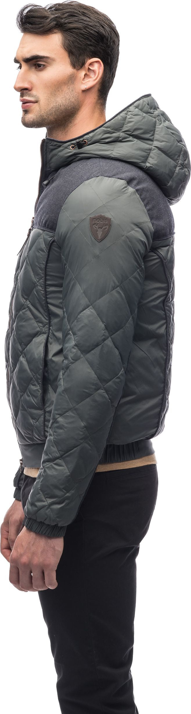 A person wearing a quilted jacket with a hood.