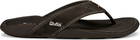 A brown flip-flop with white stitching and the text "Olukai" on the side.