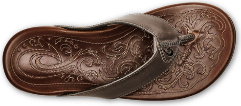 Brown sandal with an intricate embossed floral design.