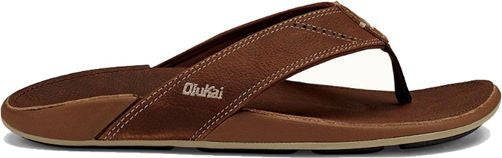 A brown leather OluKai flip-flop sandal.