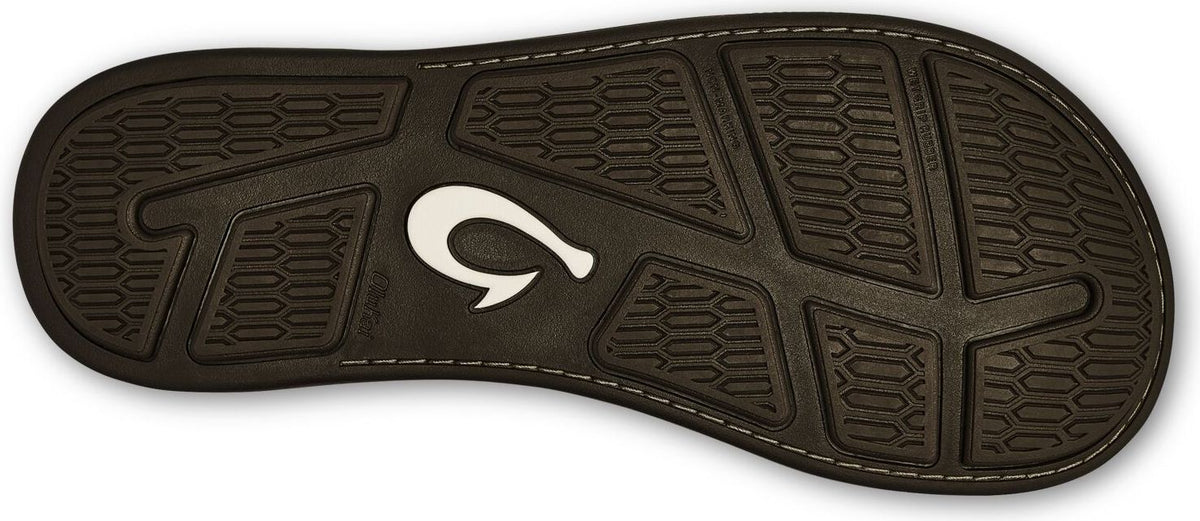 sole of a sandal with a white hook-shaped logo and patterned tread