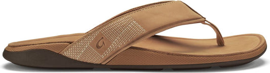 A pair of tan sandals with a textured strap.