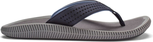 A gray flip-flop with a navy blue strap featuring small holes.