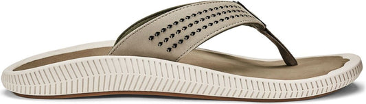 a tan flip-flop with studs on the strap