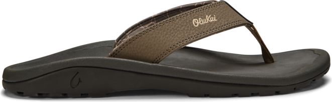A brown sandal with the text "Olukai" on the upper.