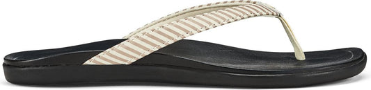 A sandal with tan and white striped straps.