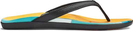 A pair of black flip-flops with a bright yellow, white, and teal sole.