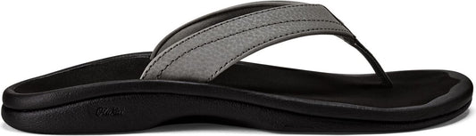 A gray sandal with a black sole.