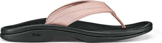 A peach-colored leather flip-flop with a black sole.