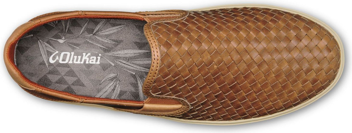 A brown woven slip-on shoe with a white sole, viewed from above, featuring a logo on the insole.