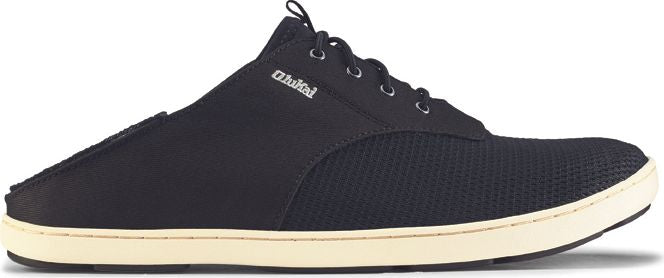 A black casual shoe with laces and a cream-colored sole.