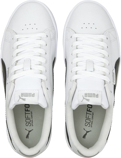 Two white sneakers with laces and the word "SOFTFOAM" printed inside.