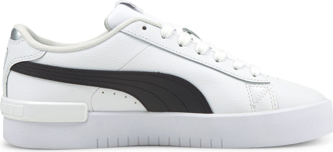A white sneaker with a thick white sole and a black stripe.