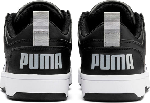 Rear view of black and white sneakers with the word PUMA printed in silver.