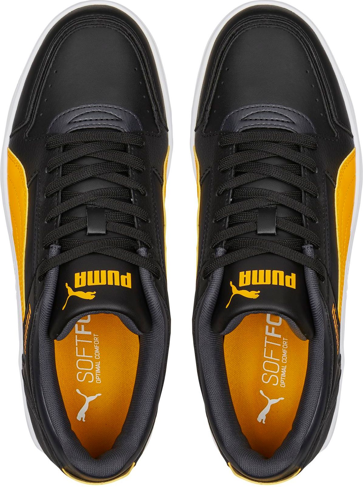 Overhead view of black and yellow sneakers with white soles and black laces.