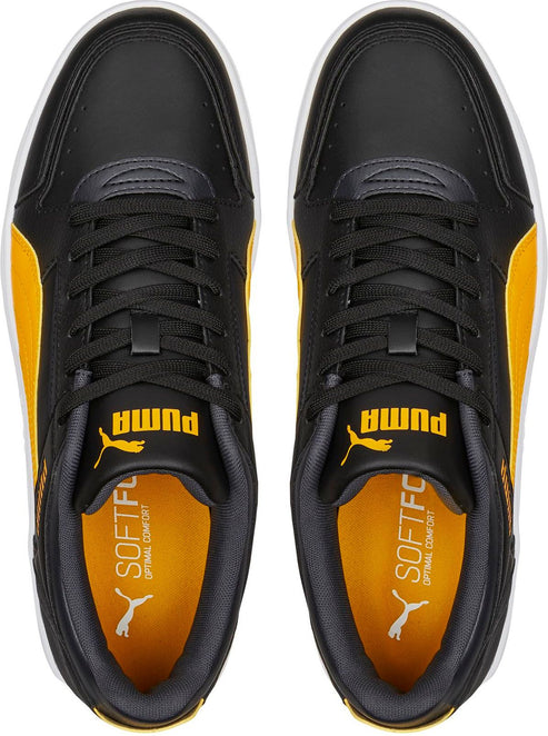 Overhead view of black and yellow sneakers with white soles and black laces.