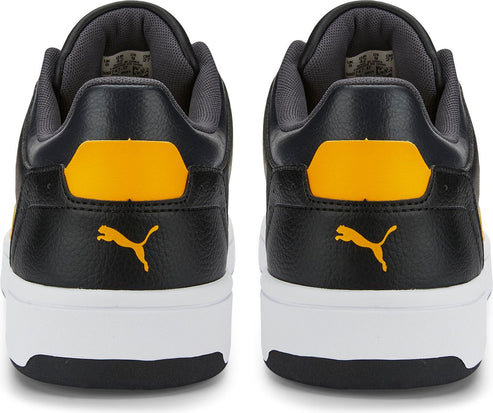 Back view of two identical black sneakers with yellow accents and white soles, displaying the brand's logo.