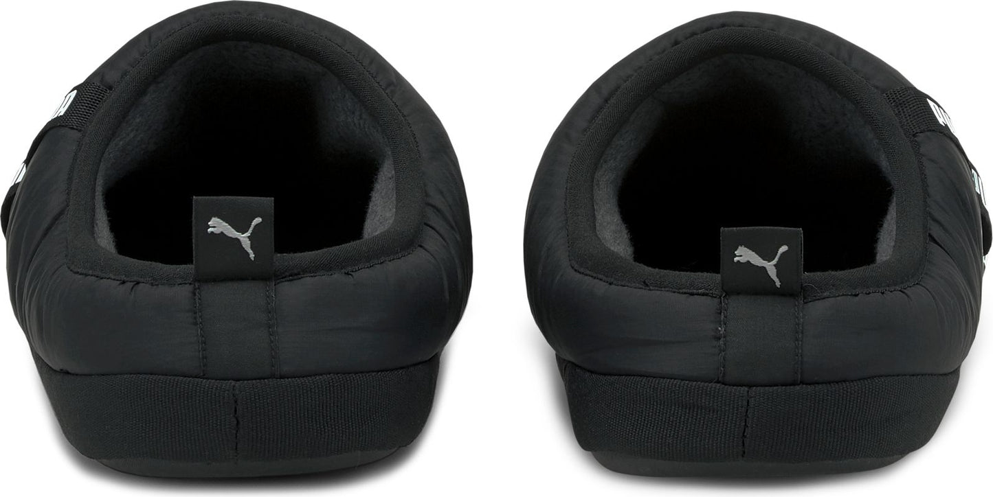 Two back-facing black slippers with Puma logos on the heel.