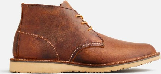 A brown leather boot with yellow laces and a beige sole.
