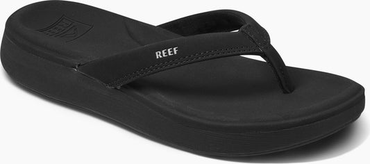 Black flip-flop with the text REEF on the strap.
