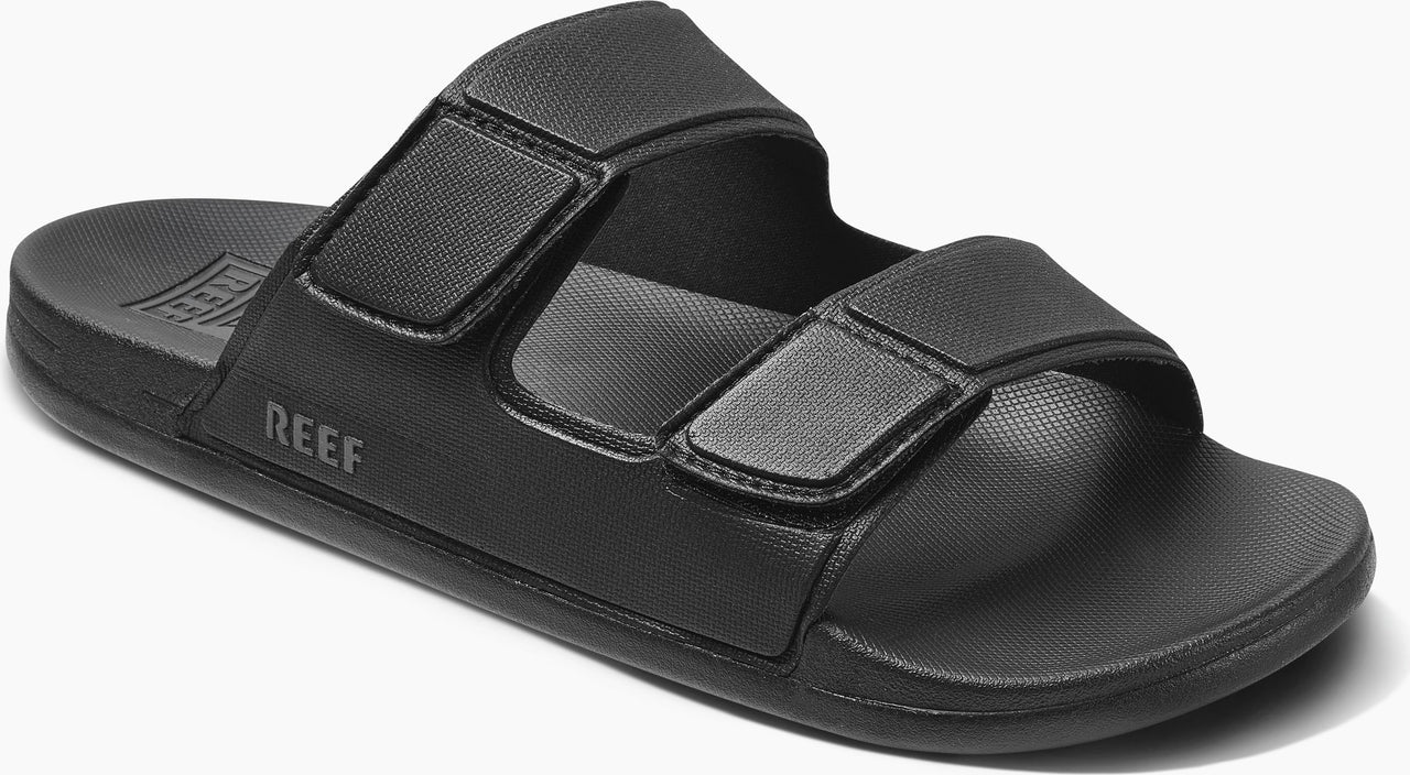 Black sandal with two adjustable straps and the word "REEF" on the side.