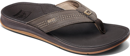 A close-up of a brown sandal with a toe post.