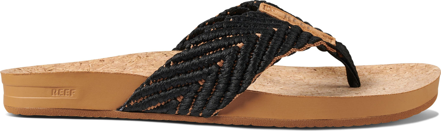A black woven sandal with a brown sole.