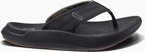 A black sandal with a Reef logo.