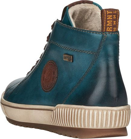 Back angled view of teal-colored high-top sneaker with brown accents, padded brown fur-like interior, logo patch on side, and white and brown textured sole.