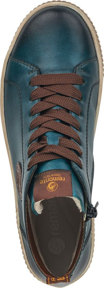 A top-down view of a blue leather sneaker with brown laces.