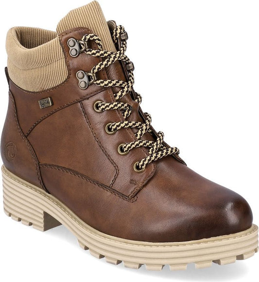 Brown ankle boot with corduroy detail around the ankle, metal eyelets, and thick cream colored sole.