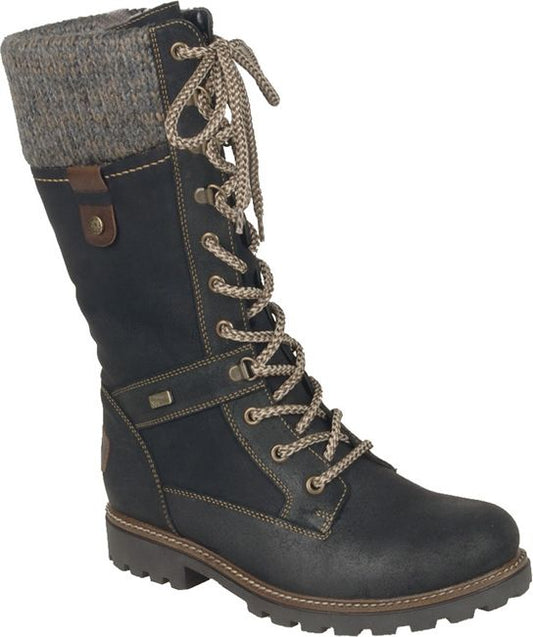 A women's knee-high black boot with a tan lace-up design, gray knitted cuff, and lug sole.