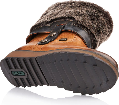 Tan leather boot with dark faux fur trim and lug sole.