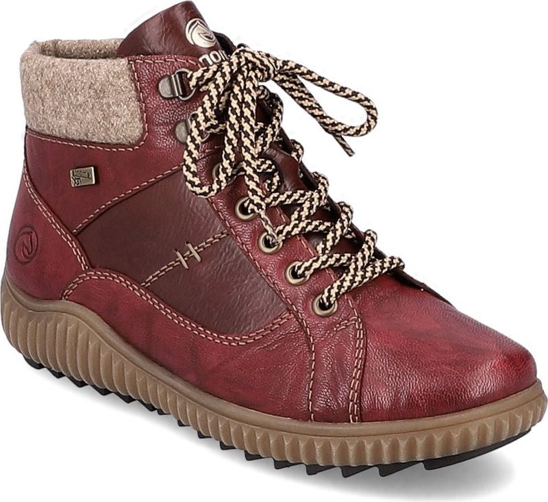 Red ankle boot with tan treaded sole, lace-up closure, and felt-like collar.