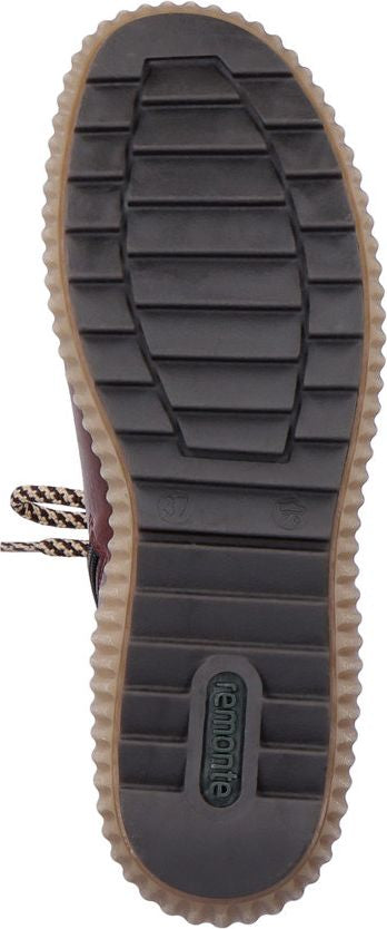 The bottom of a shoe with a brown sole and black treads. The brand Remonte is imprinted in green.