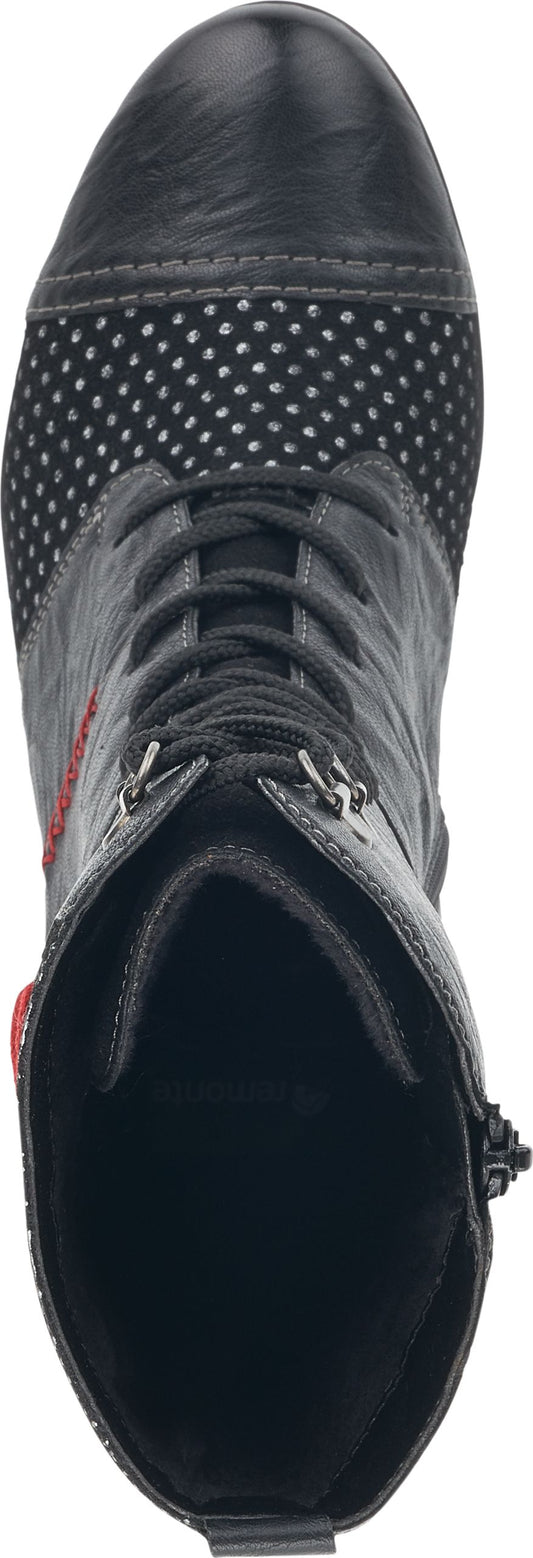 An overhead shot of a boot featuring laces, a cap toe, and polka dots.