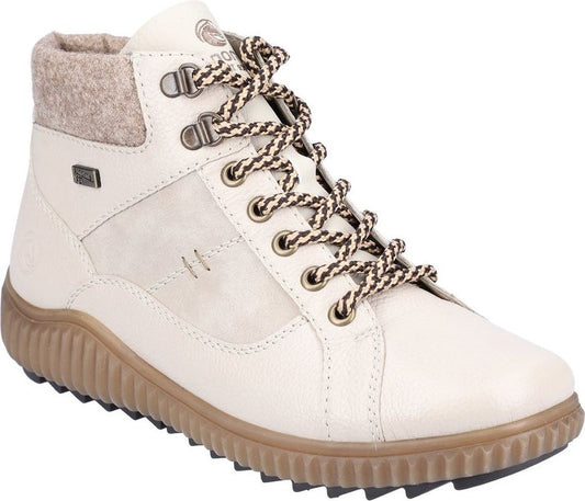 Beige ankle boot with hiking laces, padded collar and thick ridged sole.