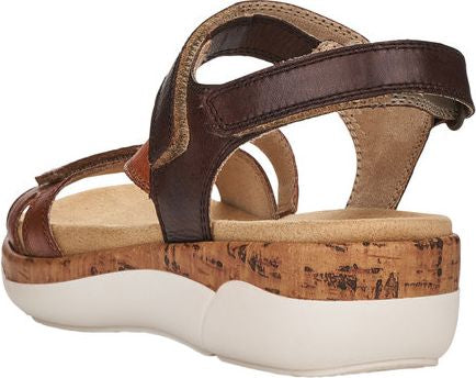 Brown leather sandals with adjustable velcro straps, cork platform and white sole.