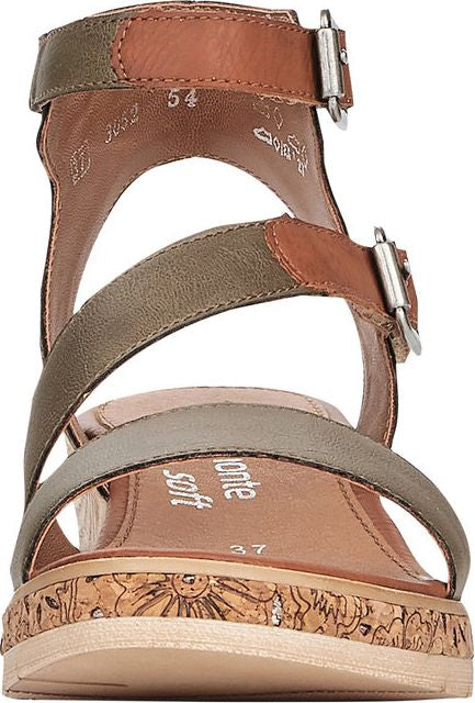 Angled close-up of multi-strap sandal featuring two-tone leather straps, adjustable buckle closures, a flower-engraved cork wedge, and a tan sole.