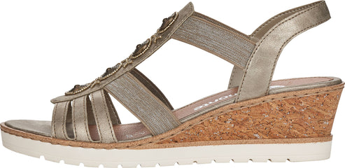 A women's sandal with metallic straps, bead accents, a cork wedge heel, and a white sole.